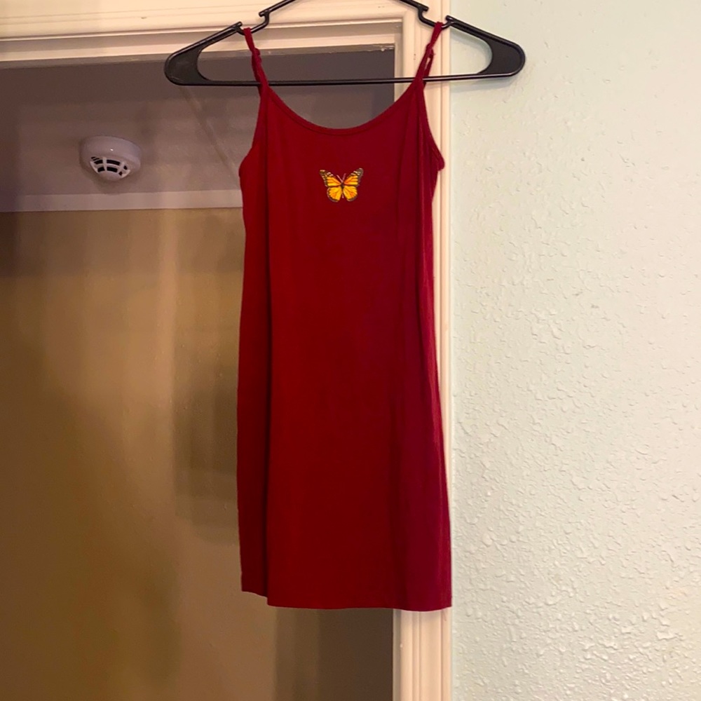 A maroon dress with a butterfly in the front